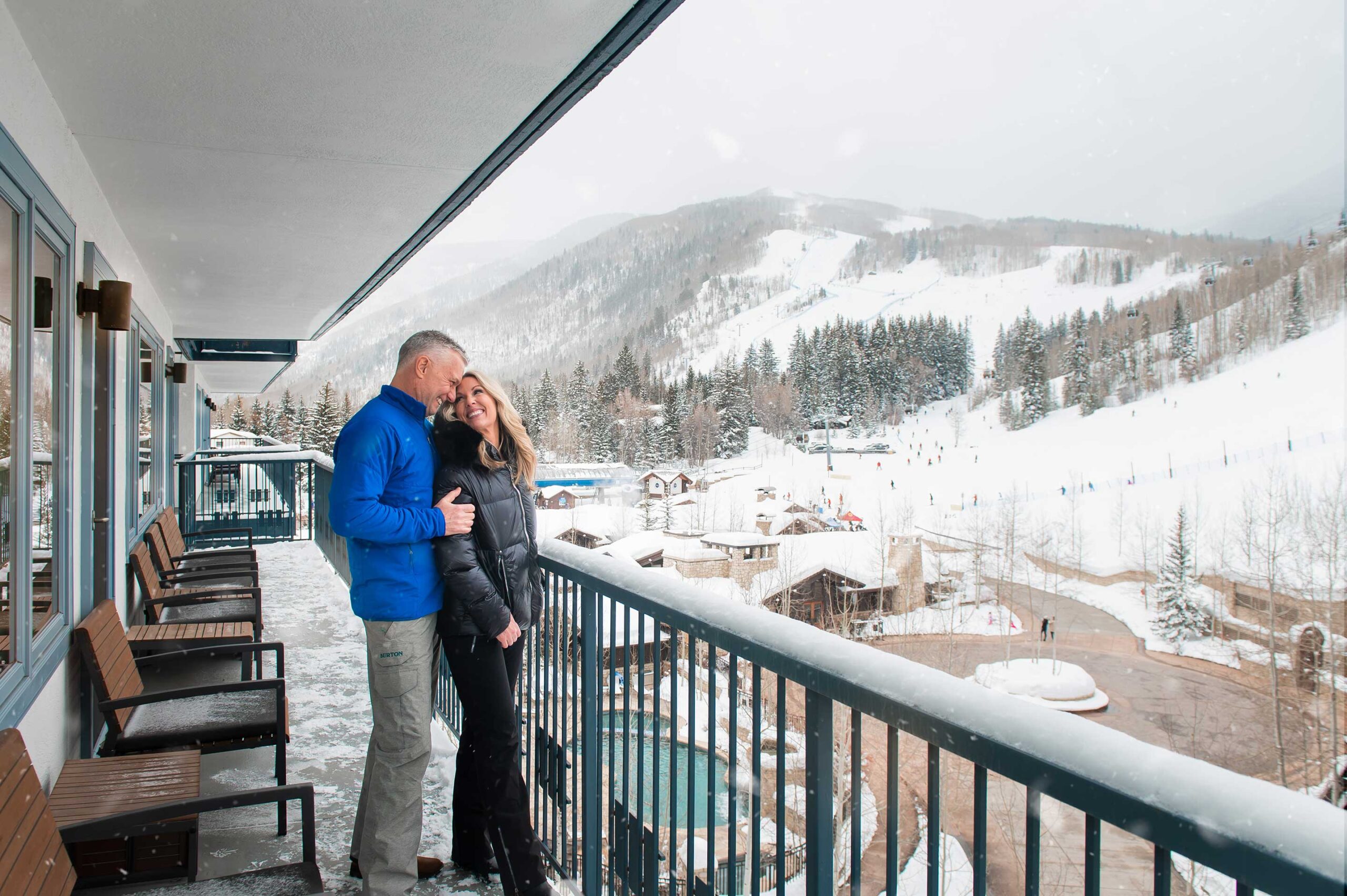 Couple on Lodge Tower balcony in winter in Vail, CO